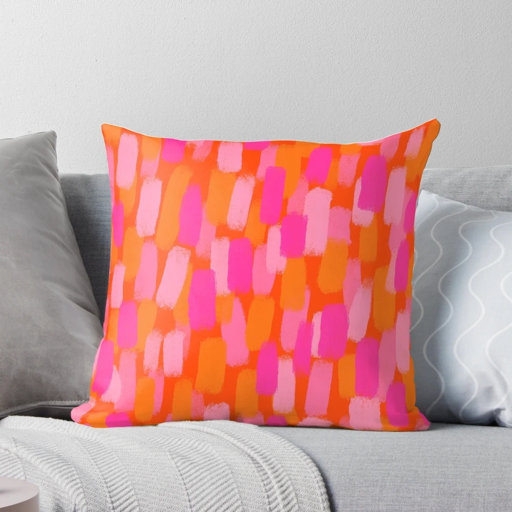 Colorful abstract art pillow with pink and orange painterly brush stroke design
