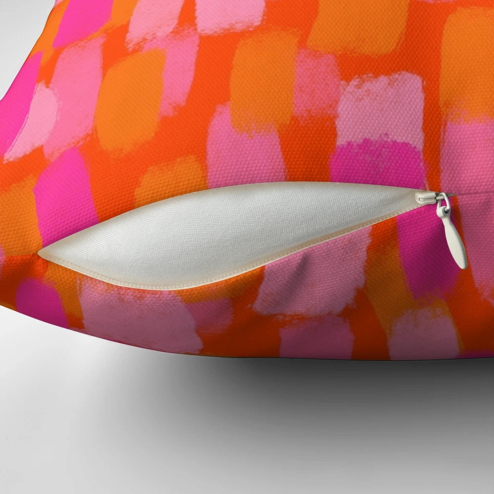 Colorful abstract art pillow with pink and orange painterly brush stroke design