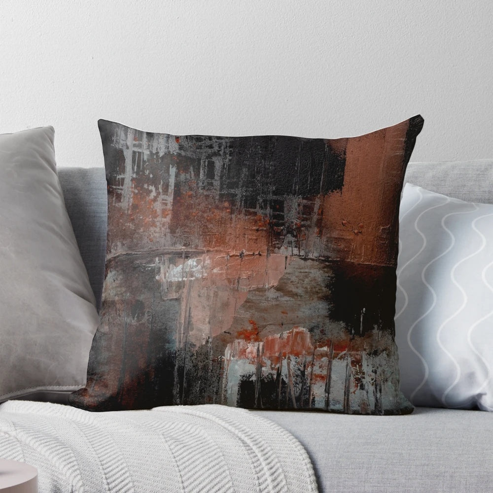 Vibrant abstract black and orange throw pillow with textured paint design, perfect for modern living room and home decor.
