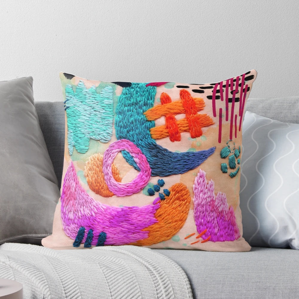 Colorful abstract embroidered pillow with geometric patterns and textured design