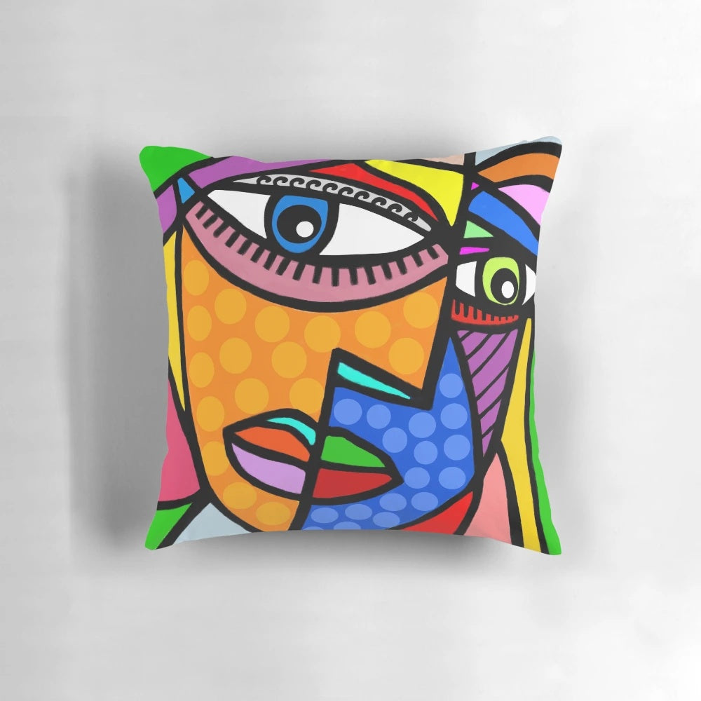 Colorful abstract art face design with dots and stripes on a decorative throw pillow