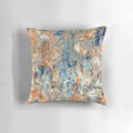 Decorative abstract floral throw pillow in complementary blue and orange colors