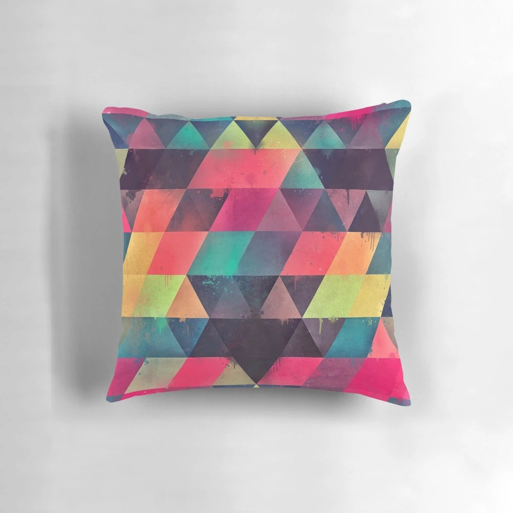 Colorful abstract geometric patterned pillow with bright neon triangles and modern textures