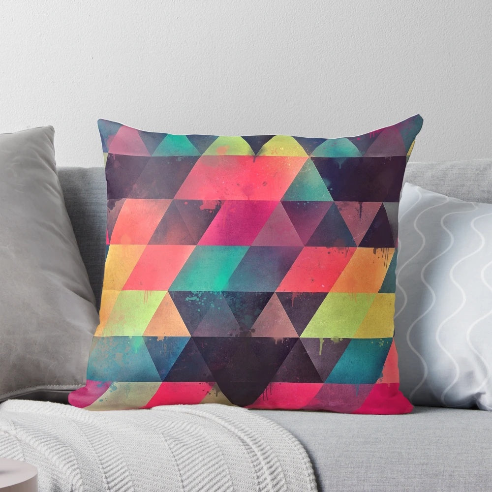 Colorful abstract geometric patterned pillow with bright neon triangles and modern textures