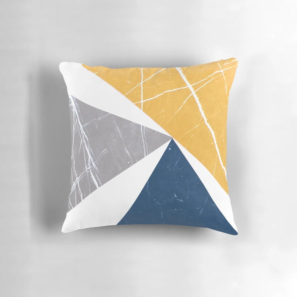 Throw pillow featuring an abstract geometric pattern in blue, yellow, and gray tones