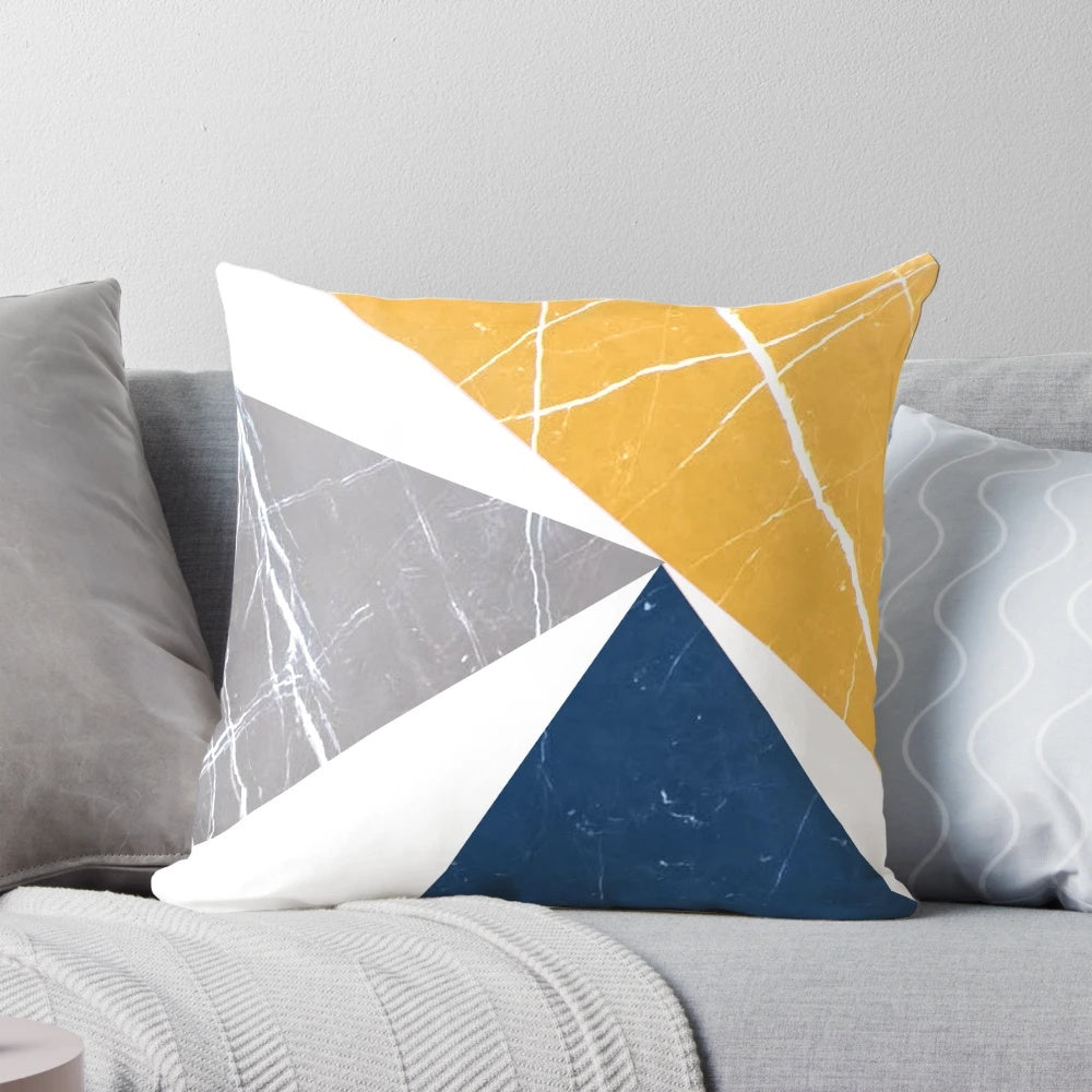 Throw pillow featuring an abstract geometric pattern in blue, yellow, and gray tones