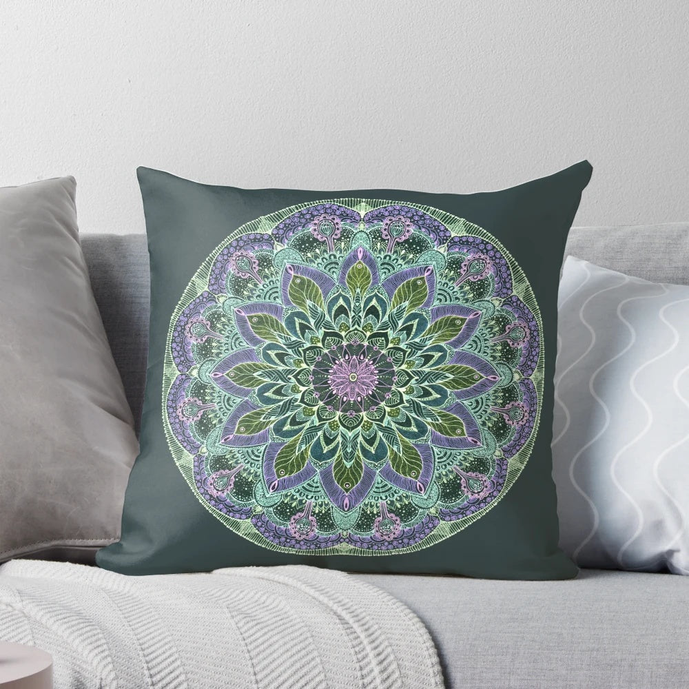 Closeup of a hand-drawn abstract mandala design on a dark-colored throw pillow