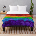 Colorful abstract paint splatter pattern on a plush blanket