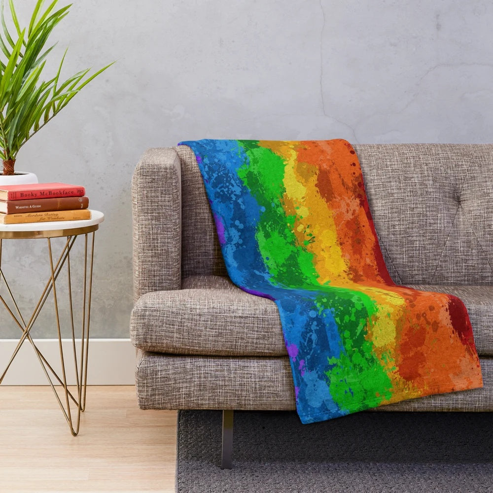 Colorful abstract paint splatter pattern on a plush blanket