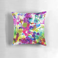 Bright and colorful abstract paint splatter design on a soft, modern throw pillow.