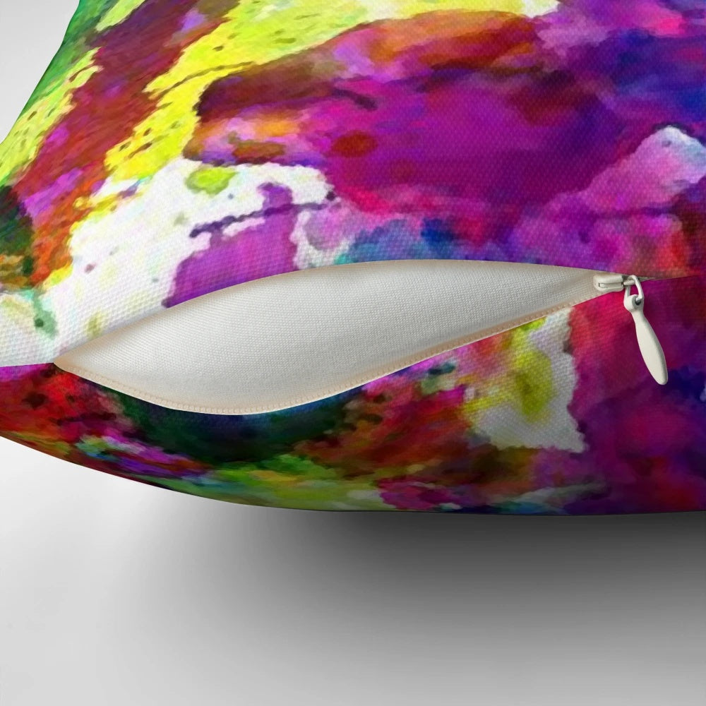 Bright and colorful abstract paint splatter design on a soft, modern throw pillow.