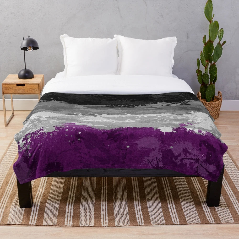 Plush blanket featuring an abstract paint splatter design in the colors of the asexual pride flag