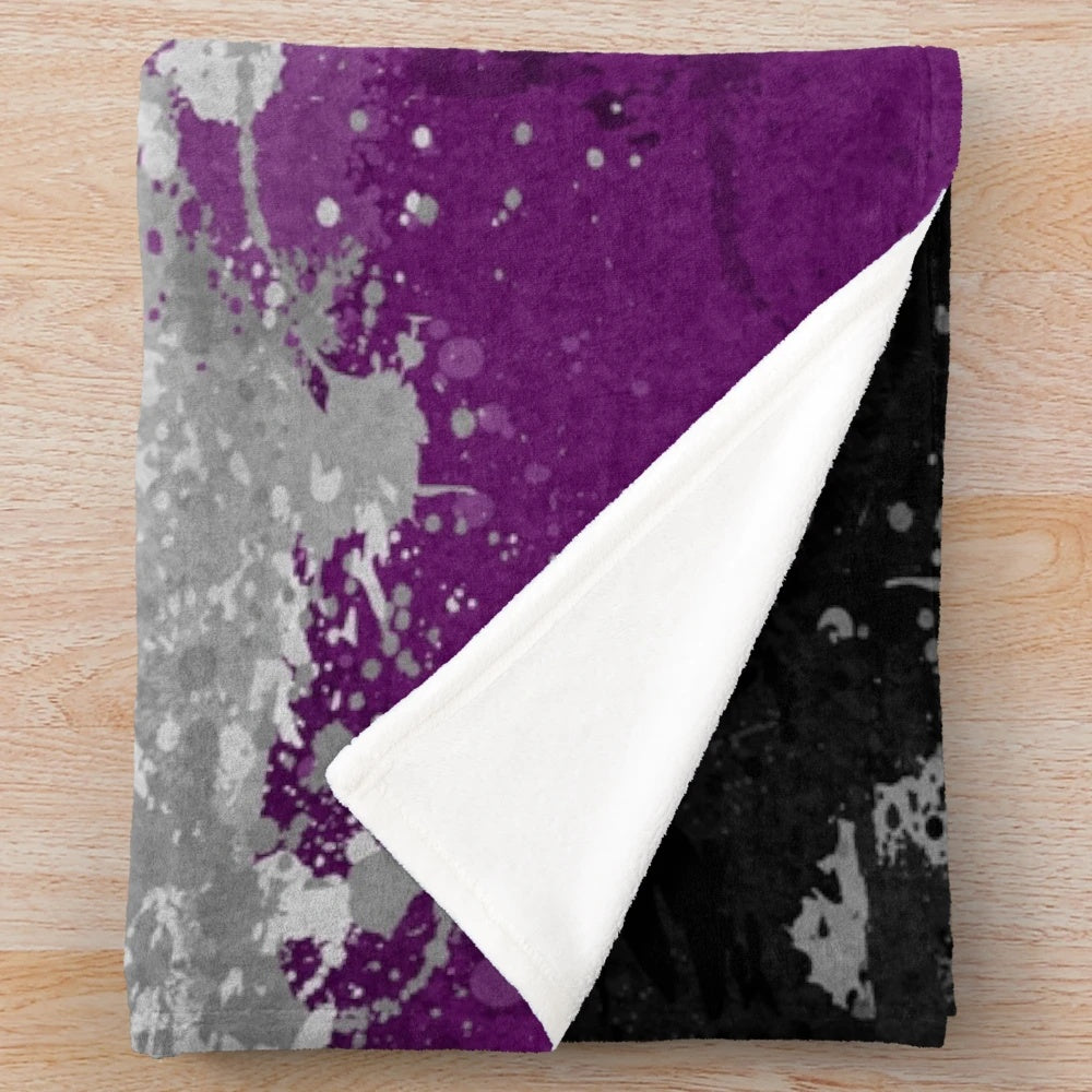 Plush blanket featuring an abstract paint splatter design in the colors of the asexual pride flag