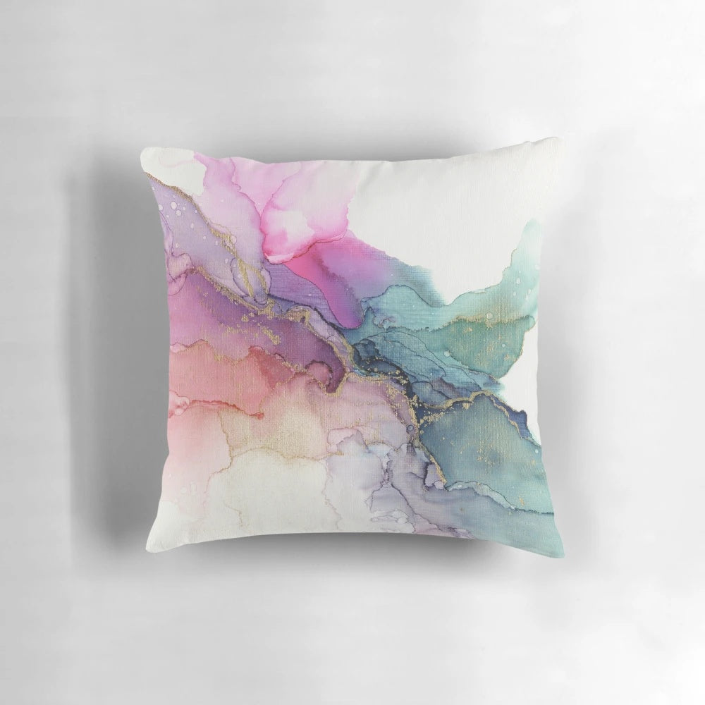 Colorful abstract painting on a canvas pillow with fluid, textured patterns in shades of turquoise, pink, coral, and violet.