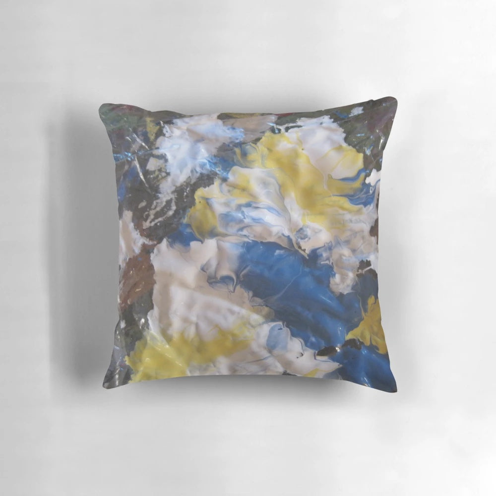 Vibrant abstract patterned pillow in shades of blue, yellow, and white