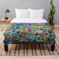 Vibrant abstract patterned plush blanket with geometric shapes and colorful design