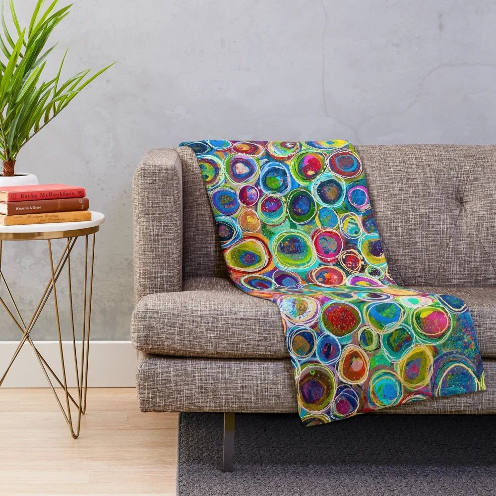 Vibrant abstract patterned plush blanket with geometric shapes and colorful design
