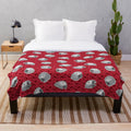 Soft and cozy plush blanket with an eye-catching African grey parrot pattern in red