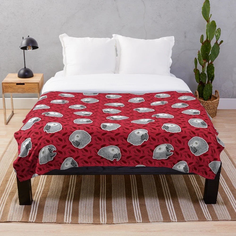 Soft and cozy plush blanket with an eye-catching African grey parrot pattern in red