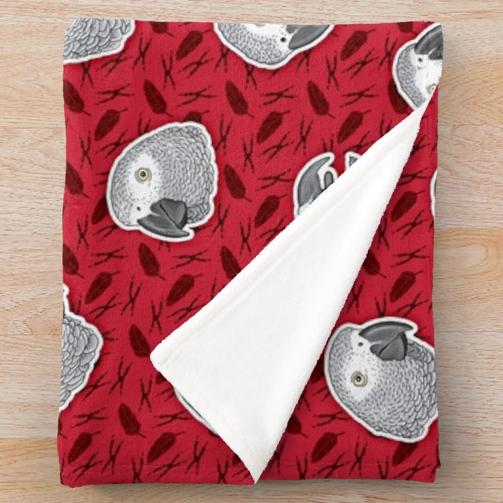 Soft and cozy plush blanket with an eye-catching African grey parrot pattern in red