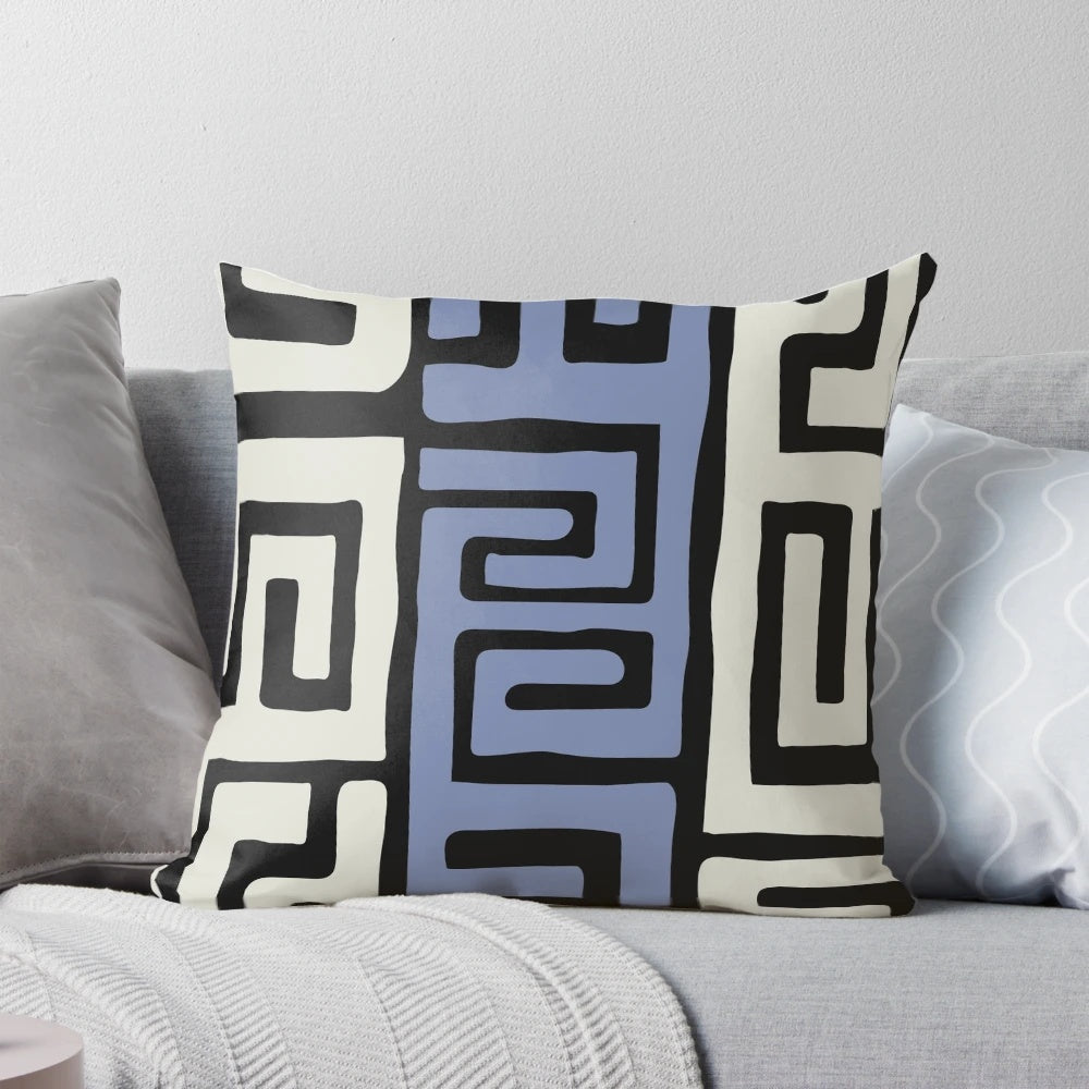 Decorative throw pillow featuring a vibrant African kuba fabric inspired pattern in cream and powder blue.