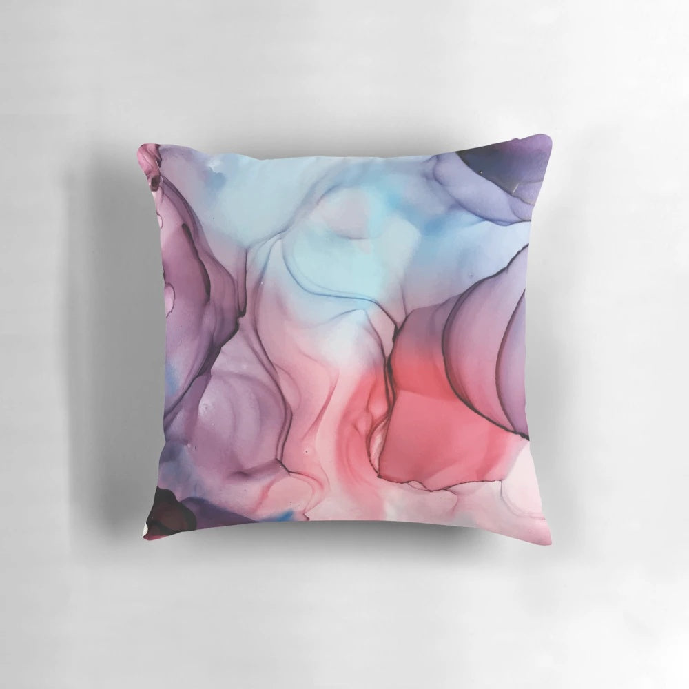 A vibrant abstract alcohol ink painting pillow featuring a bold, expressive flame-inspired design in shades of pink, purple, and blue.