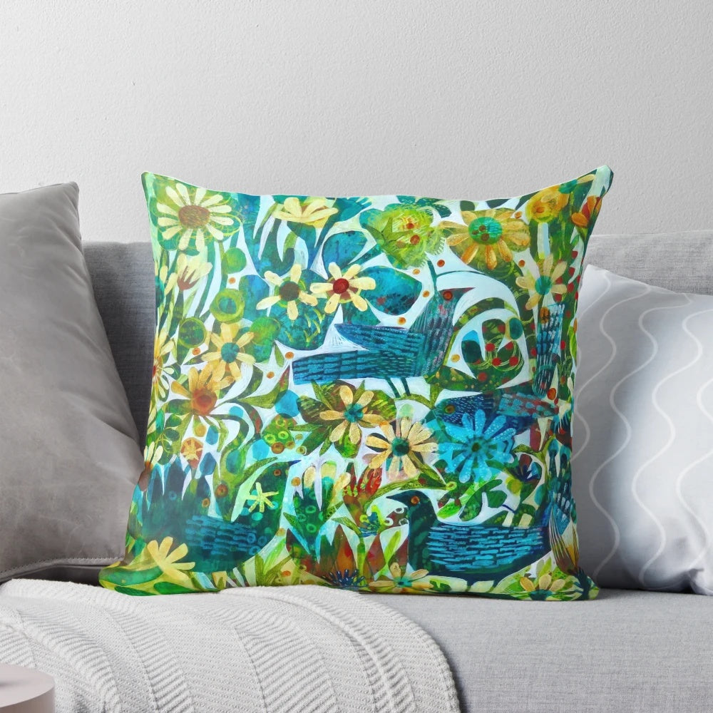 Colorful and unique Este MacLeod designed pillow with birds and flowers in a garden setting.