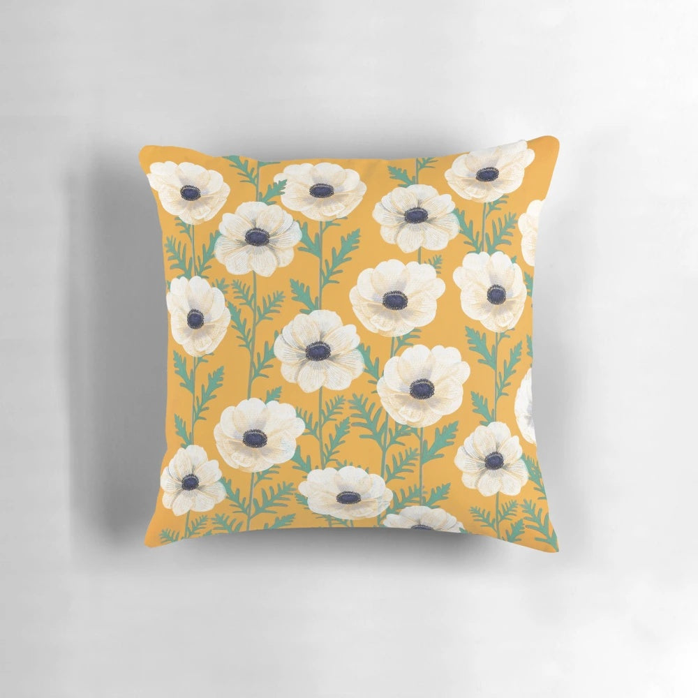 Colorful anemone flowers in a bold mango floral pattern on a decorative throw pillow