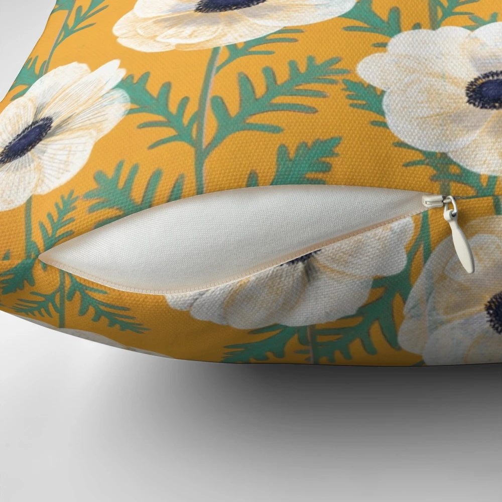 Colorful anemone flowers in a bold mango floral pattern on a decorative throw pillow