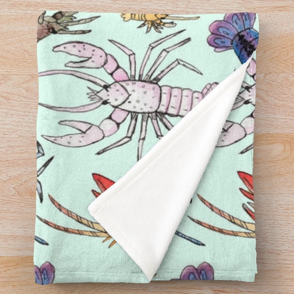 Colorful plush blanket featuring watercolor illustrations of aquatic crayfish species