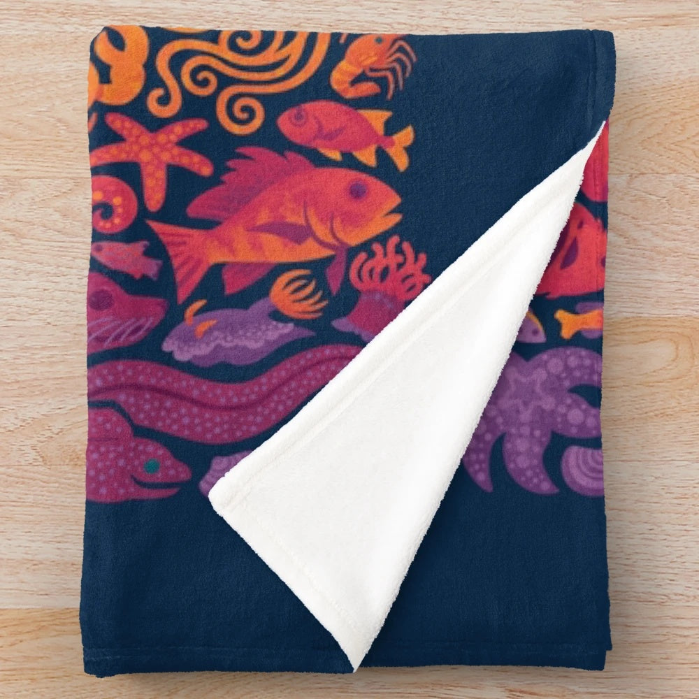 Plush blanket with colorful aquatic spectrum design featuring various ocean creatures