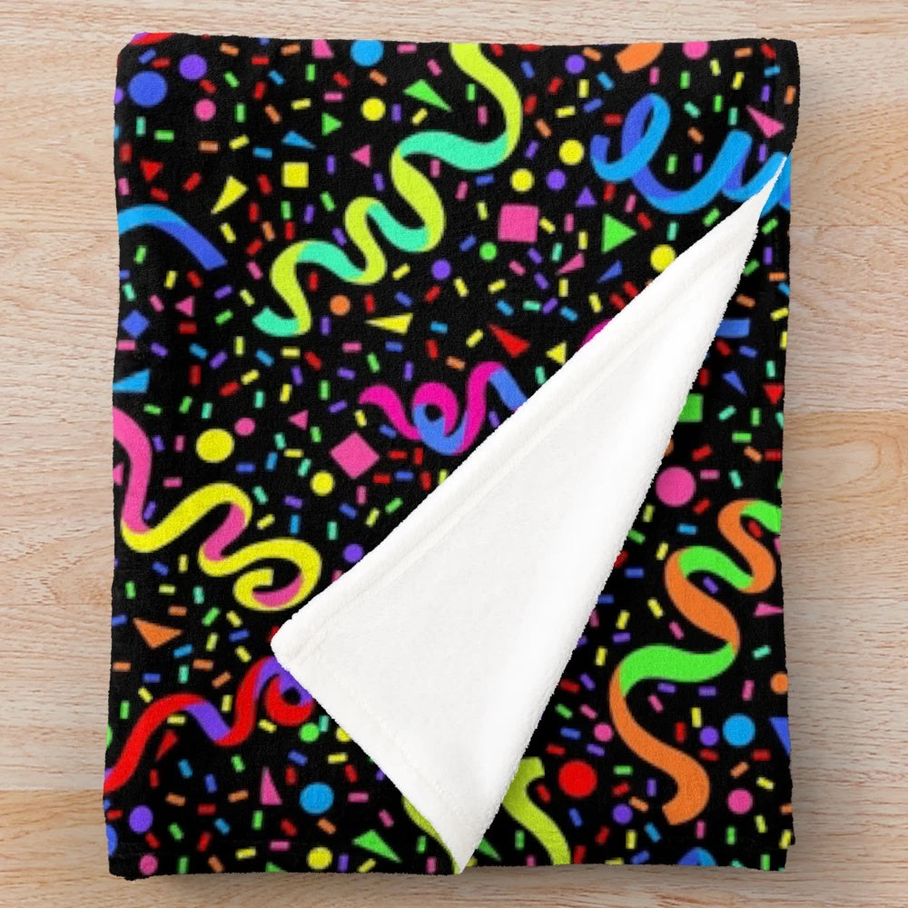 Colorful plush blanket with a retro arcade-inspired pattern of neon colors, confetti, and stars