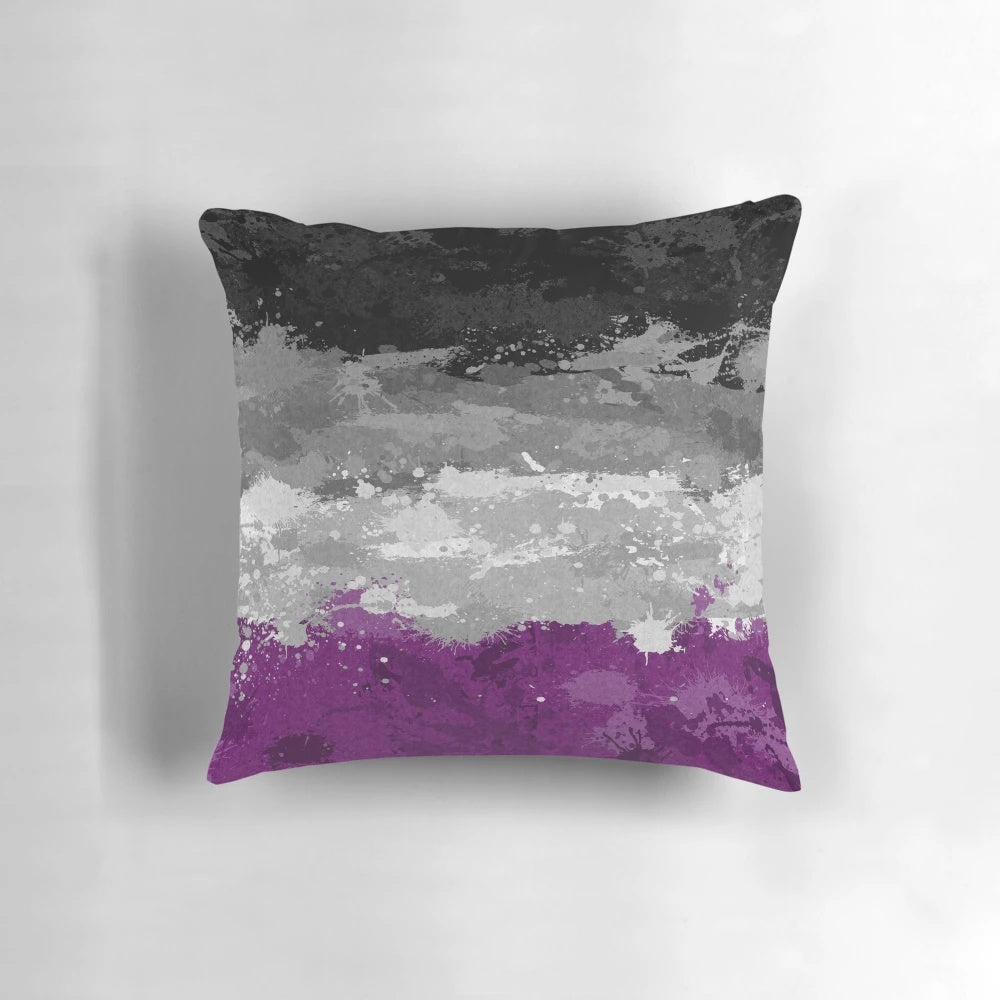 Colorful abstract paint splatter design on an asexual pride flag pattern decorative pillow.