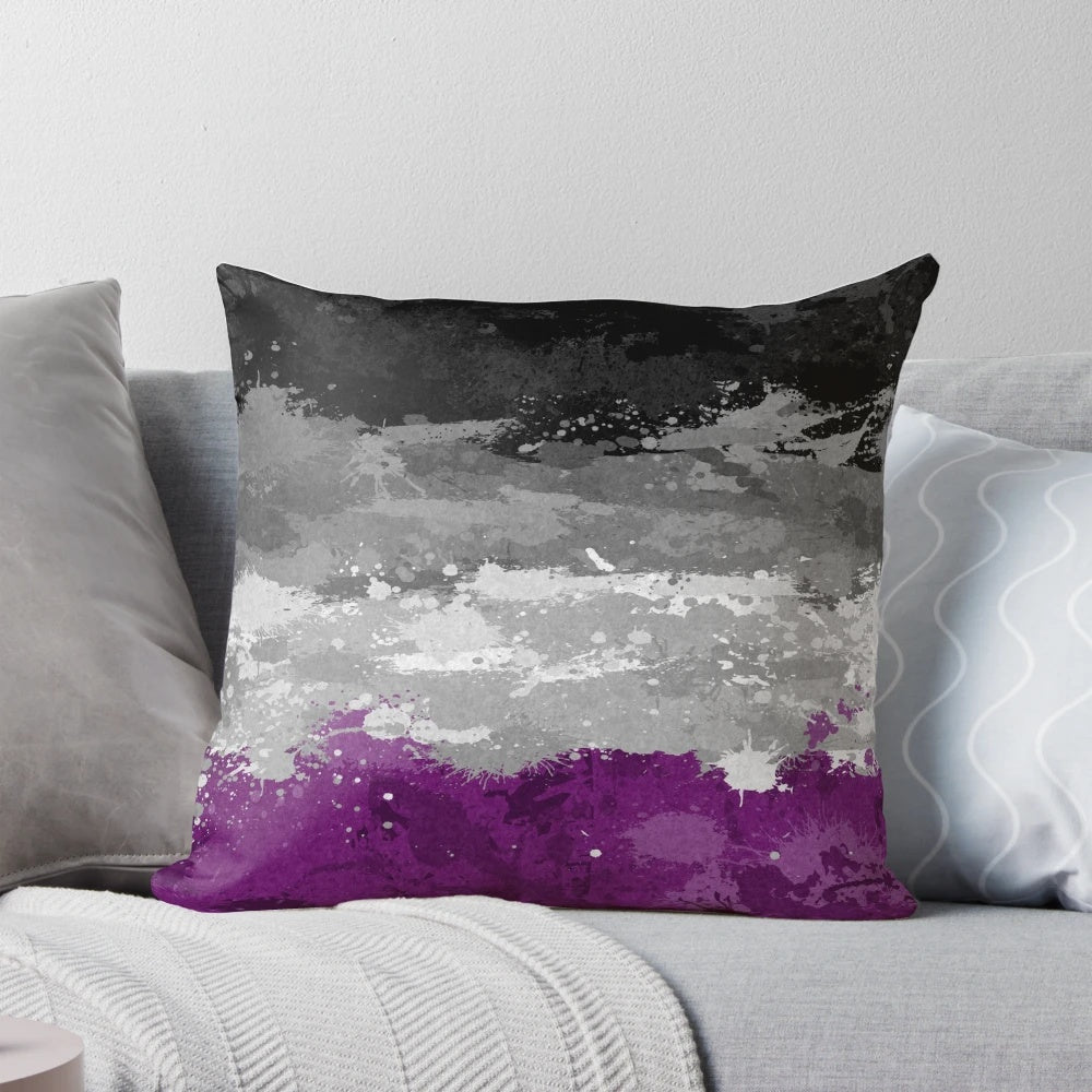 Colorful abstract paint splatter design on an asexual pride flag pattern decorative pillow.