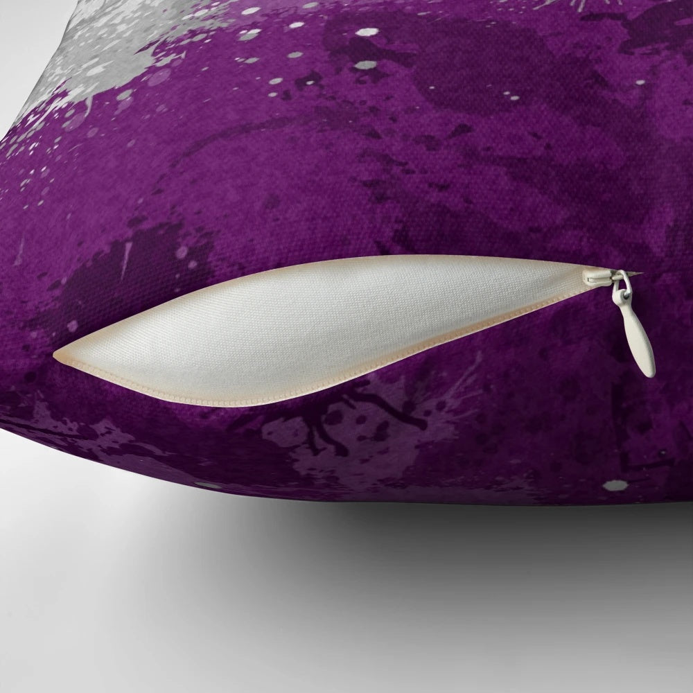 Colorful abstract paint splatter design on an asexual pride flag pattern decorative pillow.