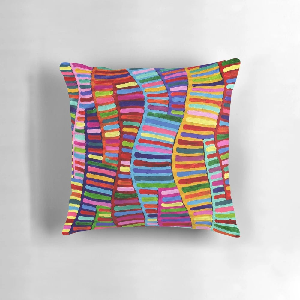 A colorful and vibrant pillow featuring a design inspired by traditional Australian aboriginal dot art.