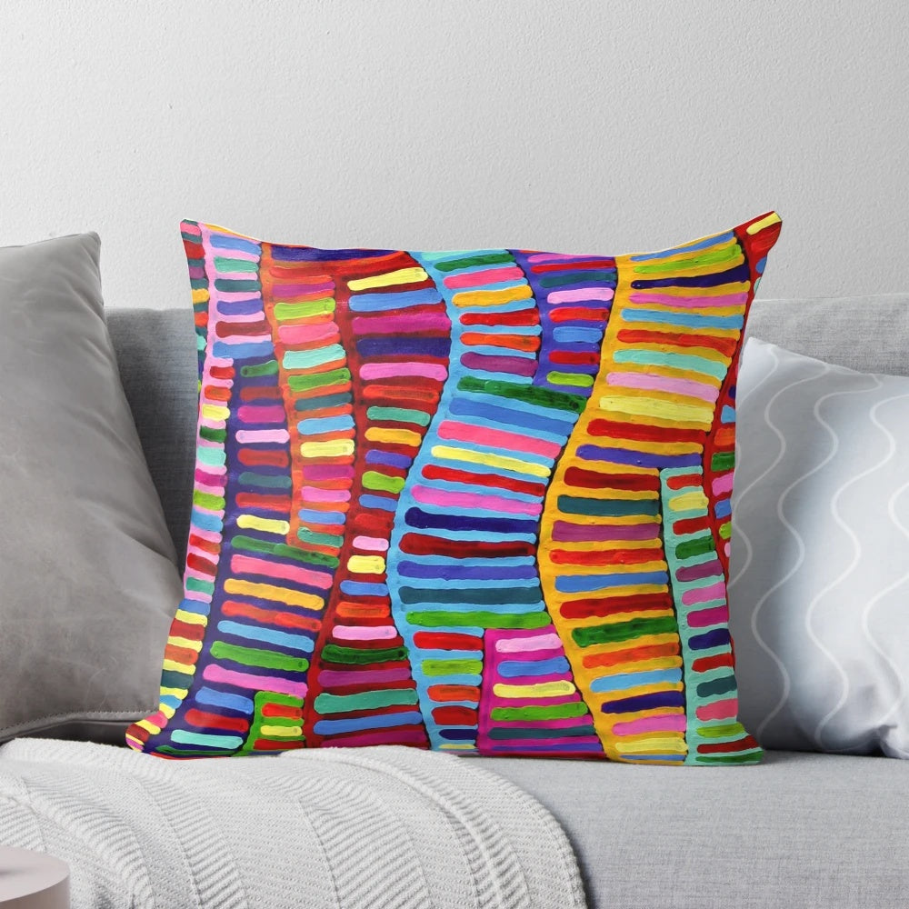 A colorful and vibrant pillow featuring a design inspired by traditional Australian aboriginal dot art.