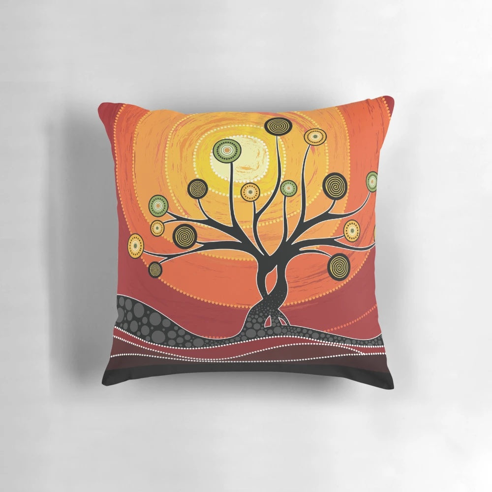 Colorful aboriginal art pillow featuring warm orange tones and traditional indigenous Australian designs.