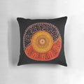 Colorful aboriginal dot art design of a sun on a decorative pillow