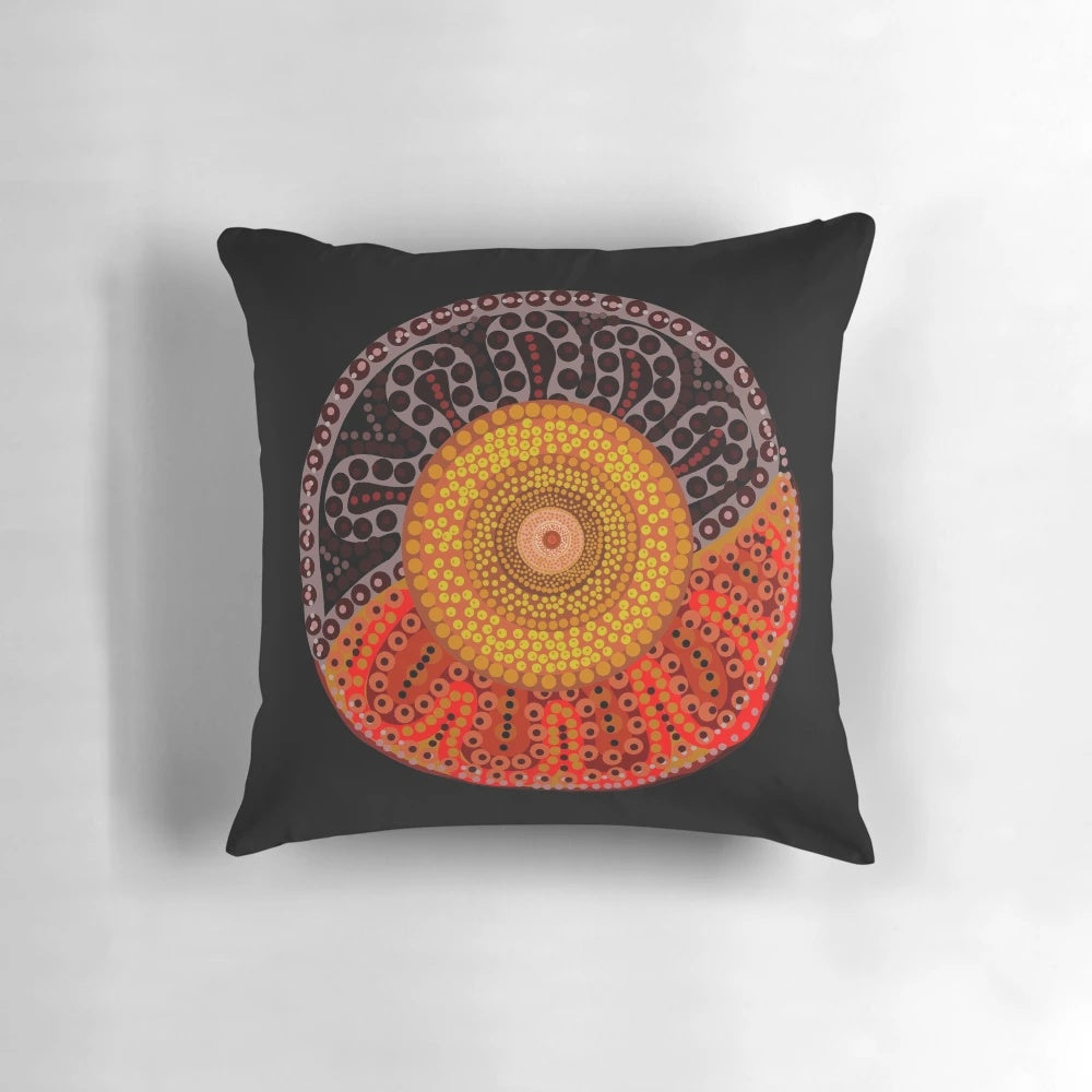 Colorful aboriginal dot art design of a sun on a decorative pillow
