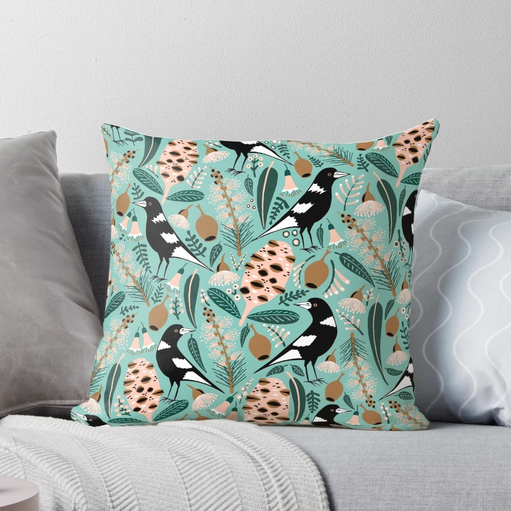 Pillow featuring an illustration of Australian magpies, banksia flowers, and other native flora