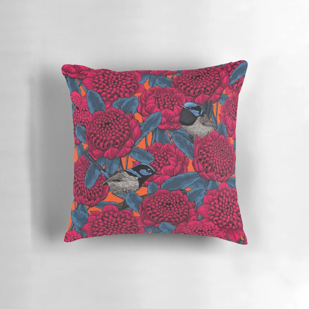 Decorative pillow featuring a vibrant illustration of a red waratah flower and fairy wrens in a botanical, nature-inspired design.