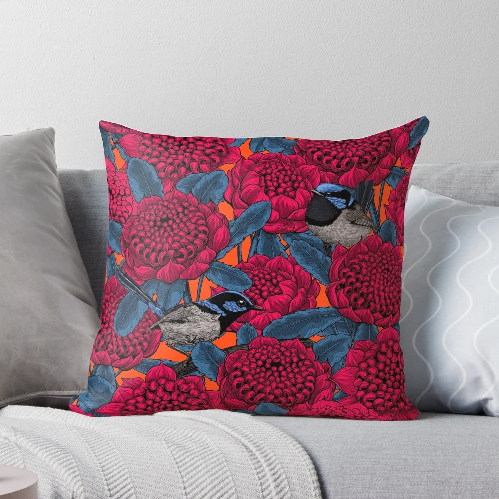 Decorative pillow featuring a vibrant illustration of a red waratah flower and fairy wrens in a botanical, nature-inspired design.
