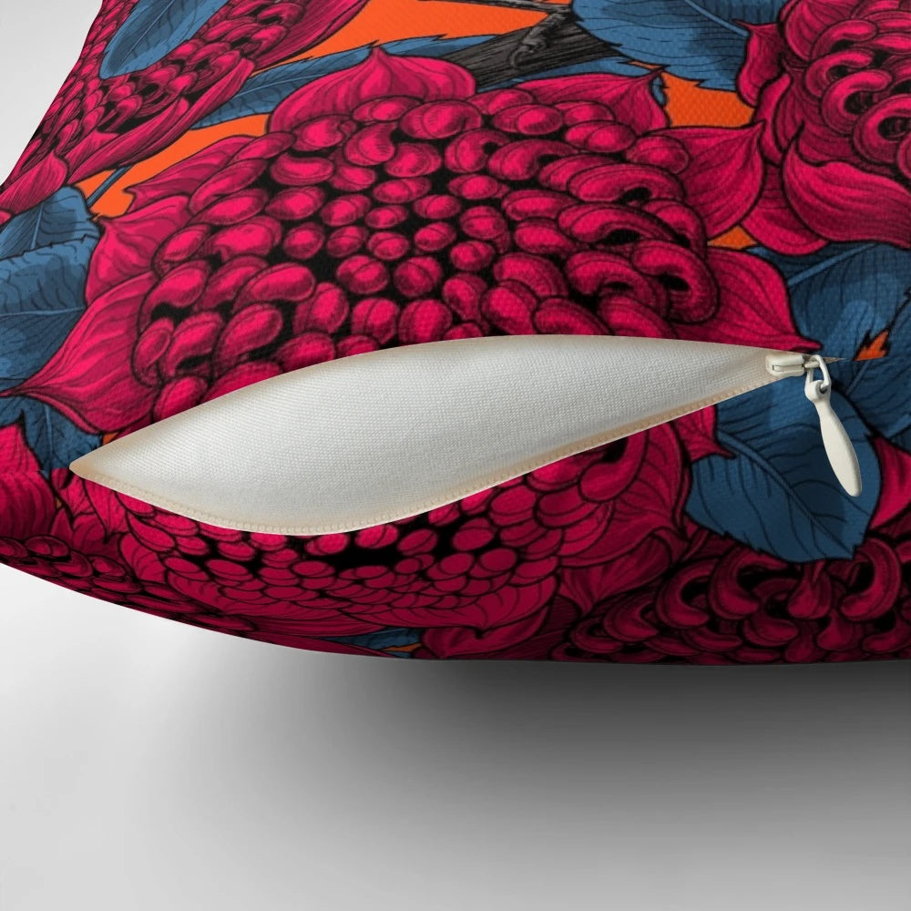 Decorative pillow featuring a vibrant illustration of a red waratah flower and fairy wrens in a botanical, nature-inspired design.