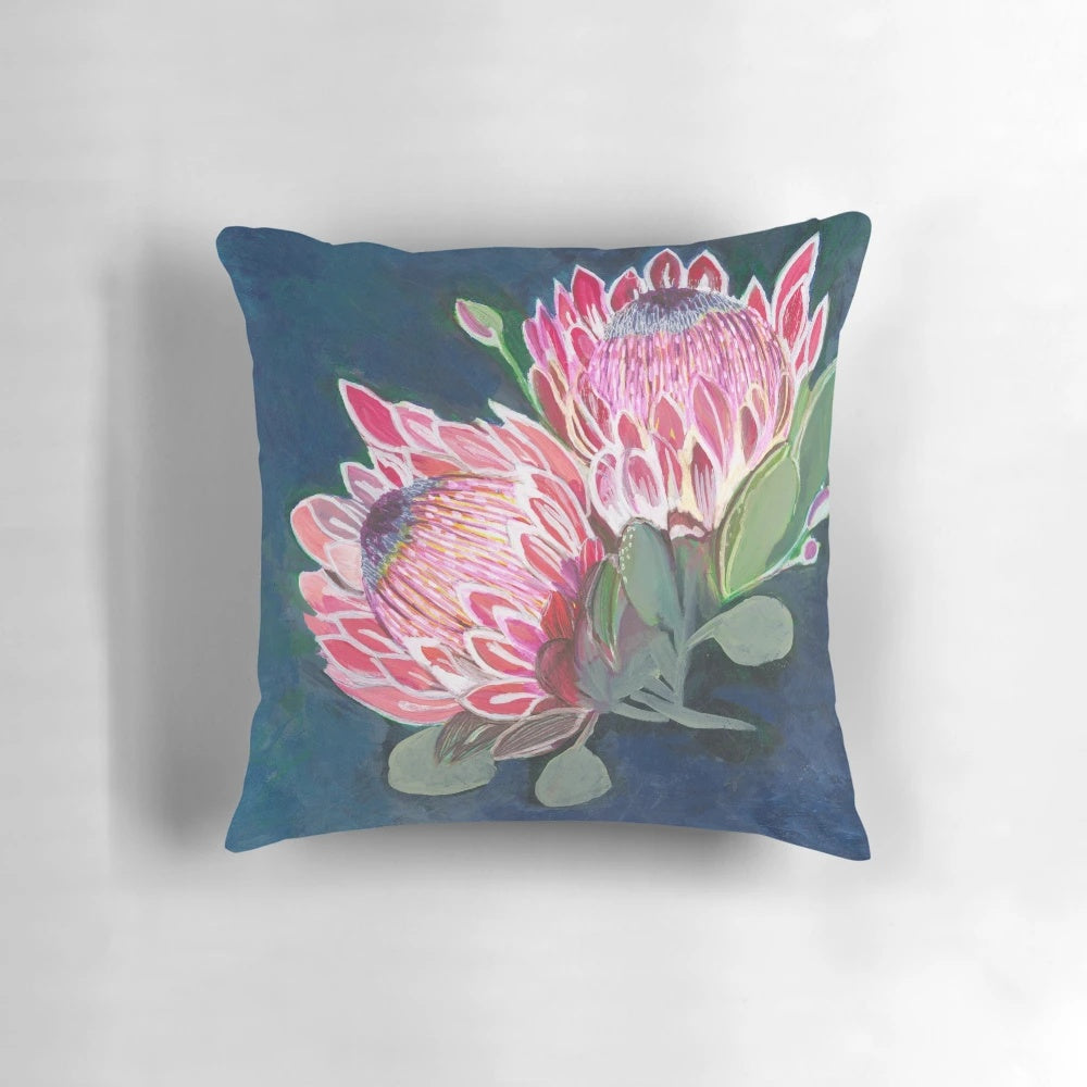 Pink and blue floral patterned decorative pillow featuring native Australian flowers