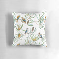 A decorative throw pillow featuring a bright and colorful pattern of Australian kookaburras, yellow waratah flowers, and green leaves on a white background.