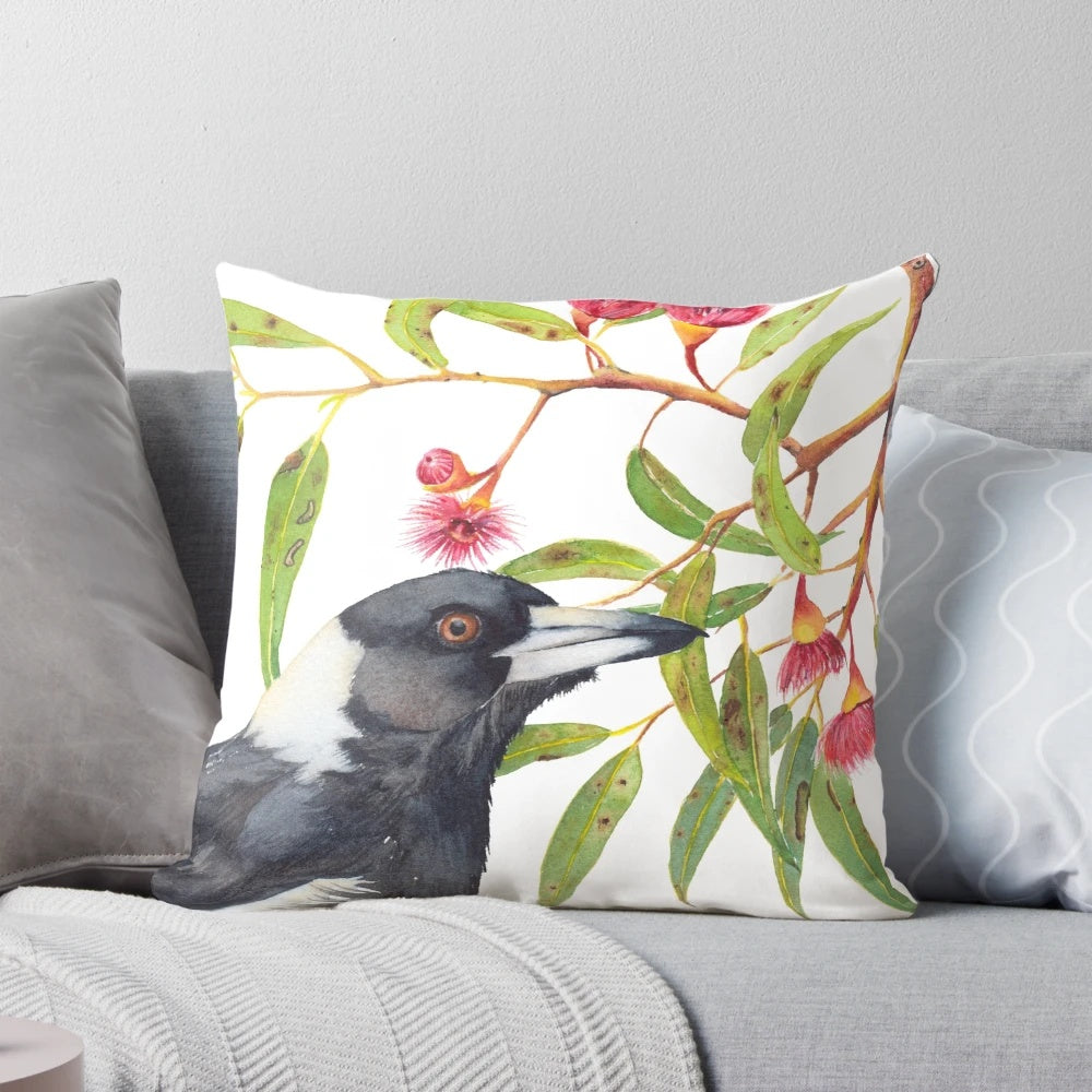 Watercolor painting of an Australian magpie perched on a eucalyptus branch with colorful blossoms.