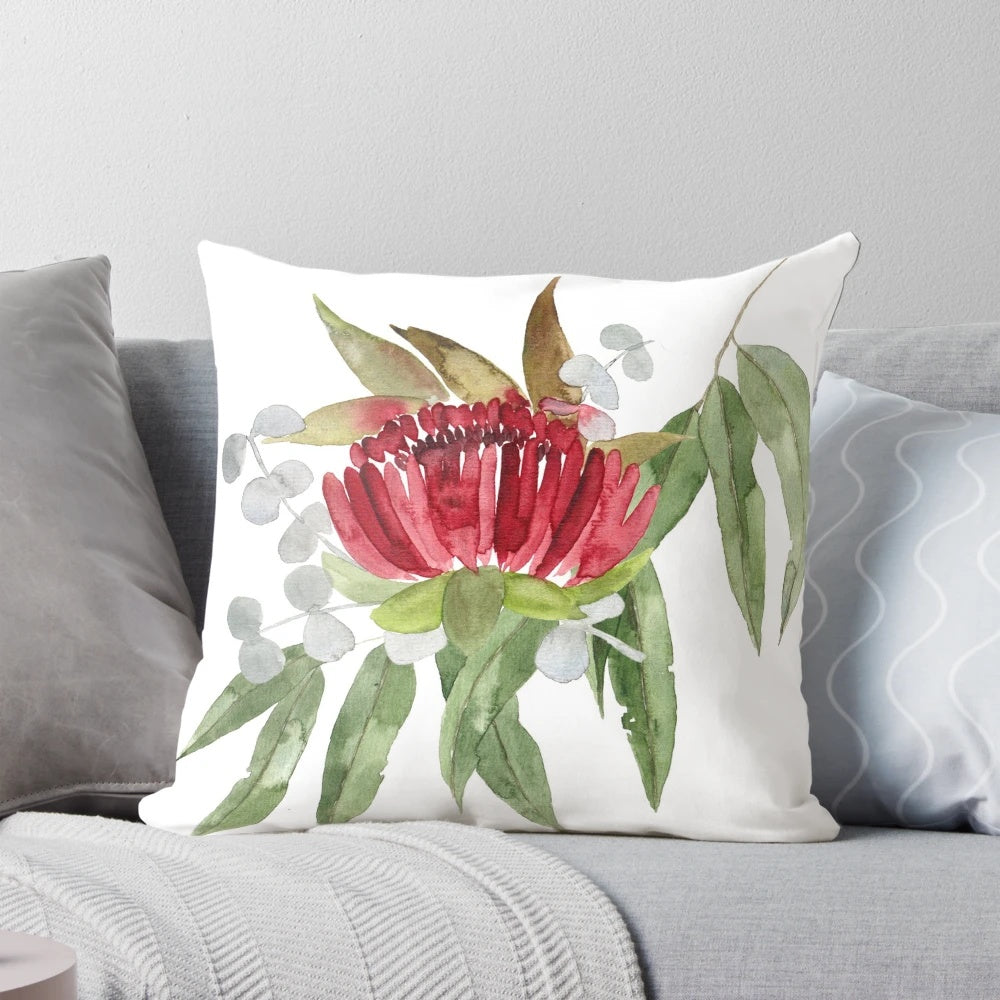 Colorful watercolor painting of Australian native bush flowers and leaves on a decorative pillow