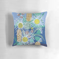 Decorative pillow showcasing a colorful pattern of Australian native flowers, including flowering gum, bottlebrush, and gumnuts.