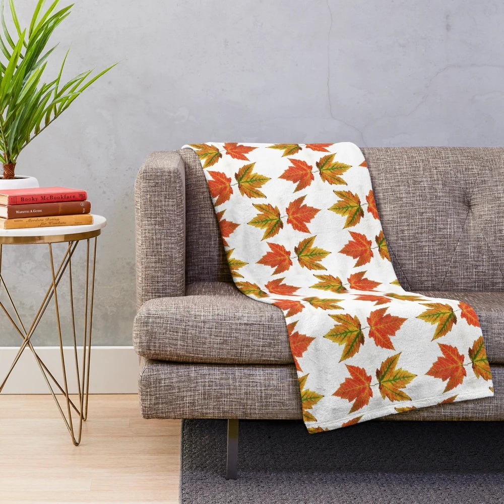 Autumn leaves plush blanket featuring a vibrant orange and red fall foliage design